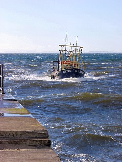 Picture of a fishing boat coming into Girvan harbour